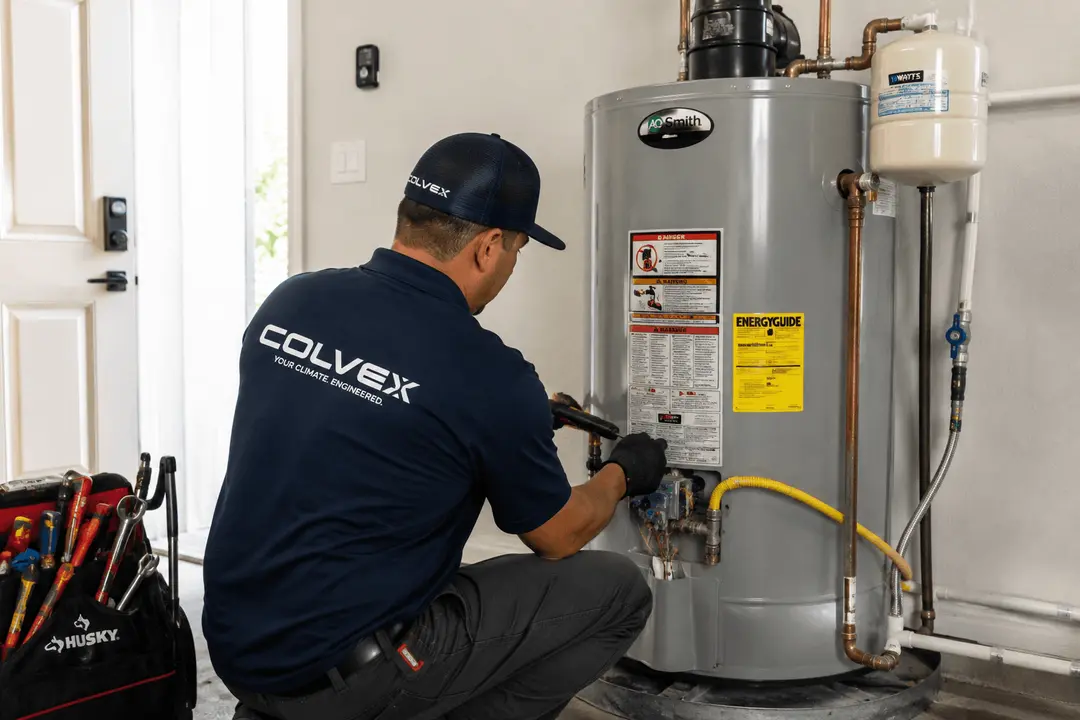 Colvex technician repairing a water heater at a DFW home