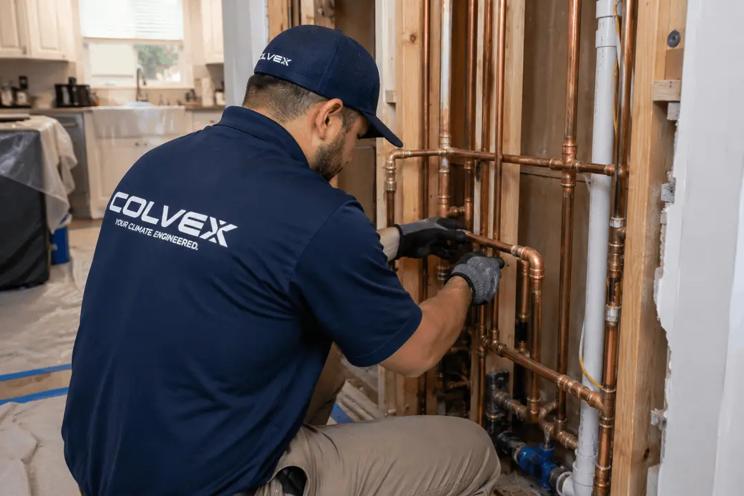 Colvex technician performing a whole-home re-pipe at a DFW home